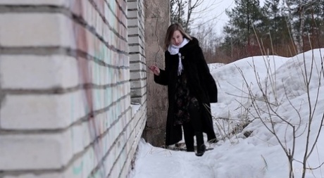 Blonde girl Alice Klay pisses in a window frame on a winter