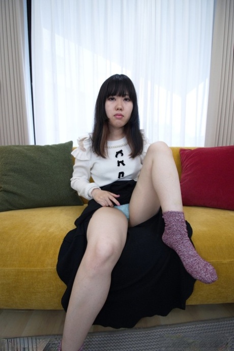 Japanese teen Eri Mizuno plays with her beaver after getting naked