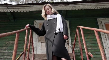 Blonde girl Alice Klay takes a piss on rusty steps on a chilly day