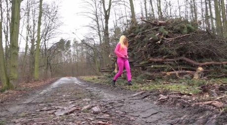 Blonde girl Delphine takes a badly needed piss near some fresh cut trees