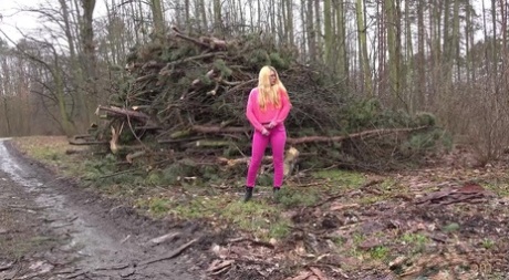 Blonde girl Delphine takes a badly needed piss near some fresh cut trees