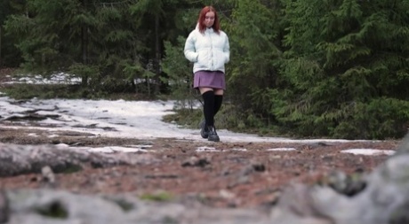 Redheaded girl Nikky B takes a badly needed piss up against a tree