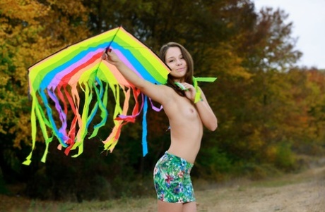 Sweet brunette teen Emmy gets totally naked after flying a kite