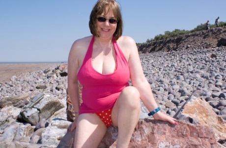 Mature UK plumper Speedy Bee takes off her bikini top during a trip to the sea