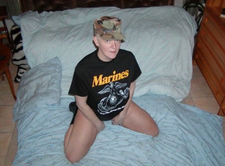 Older blonde woman Tiffany Pearl gets naked in black boots and a military cap