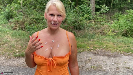 Blonde amateur Sweet Susi poses on a paved road with cum on her face and chest