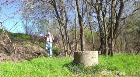 White girl Claudia Macc takes a badly needed piss upon a concrete platform