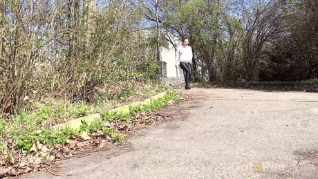 White girl Lara Fox pulls down black leggings while pissing on a country road