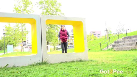 Lara Fox squats for a badly needed piss upon a public art installation