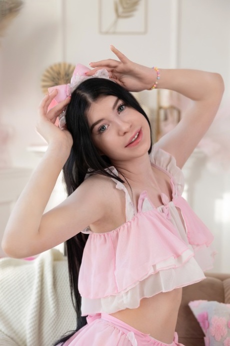 Beautiful brunette teen Kiley gets naked with a bow set in her hair