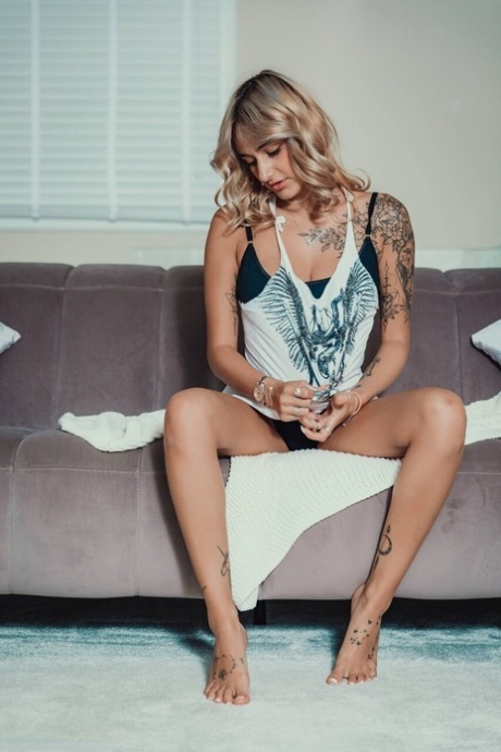 Hot blonde Seline P releases her tattooed body while getting bare naked