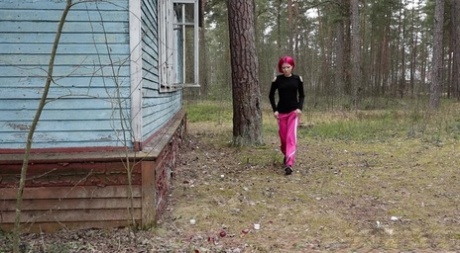 Solo girl with pink hair Vasya pisses on the porch of an abandoned dwelling