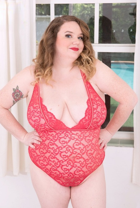 Redheaded fatty Cosmia works her way mostly free of her lingerie