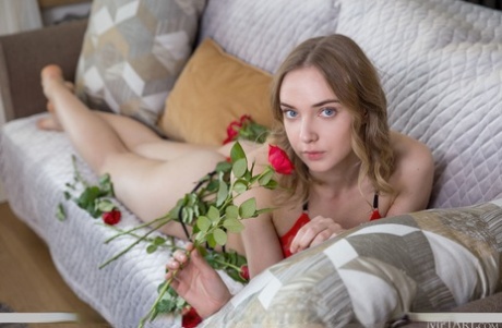 Hot teen Oxana Chic decorates herself in red roses while getting bare naked