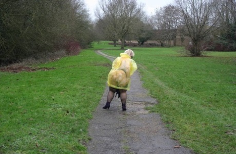 Obese British woman Lexie Cummings flashes at a park while sporting rain wear