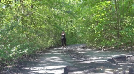 Brunette solo girl Shalina Shine squats for a badly needed piss on a dirt road