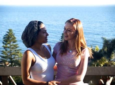 Interracial lesbians Marie Mccray & Angelina Stoli have sex near the ocean