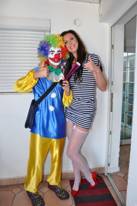 Tall female Lara Latex gets on top of a clown