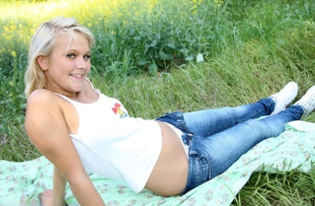 Super horny golden haired teen pleasuring herself on the picnic