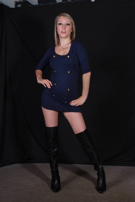 Clothed female Jay shows her creamy thighs in over the knee leather boots