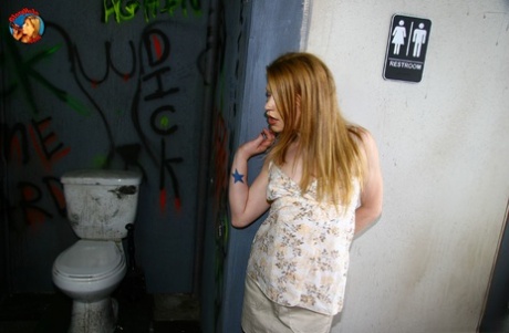 Young redhead Madison Young sucks off a BBC via a bathroom gloryhole