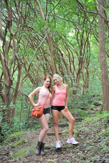 Two sexy lesbian chicks make out and spread their twats in the woods