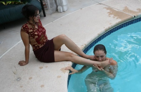 Girl in skirt dips legs in pool to get foot fetish service