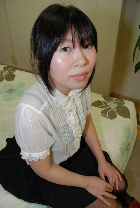 Sassy asian MILF strips down and gets her shaved gash fingered