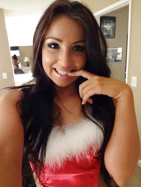 Playful brunette doxy in Christmas outfit uncovering her sexy body