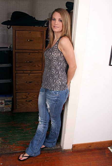 Adorable amateur in blue jeans undressing and playing with herself