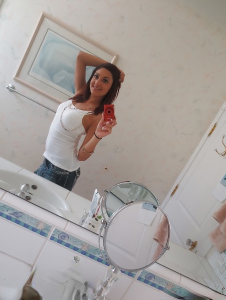 Nasty brunette slut Nikka taking couple of selfies in the bathroom