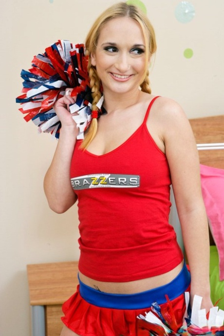 Big titted cheerleader Leslie Love is spreading and fingering pussy