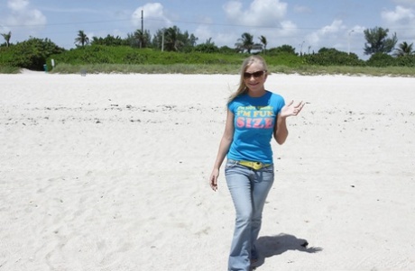 Blonde beach babe Britney Brooks posing fully clothed in denim jeans