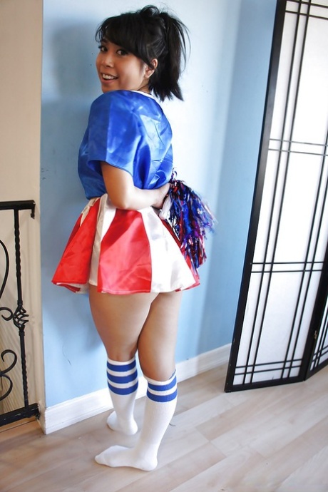 Den vesle asiatiske cheerleaderen May Lee poserer i søt uniform og sokker.