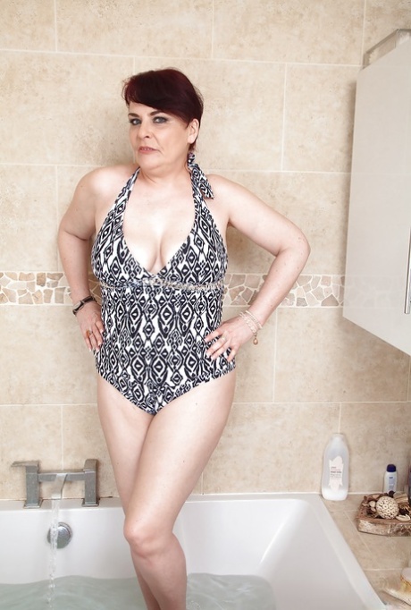 Mature woman with short hair Christina X flashing big white butt in bathtub