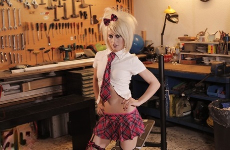 Blonde model Nora Barcelona taking off her schoolgirl clothes in slutty manner
