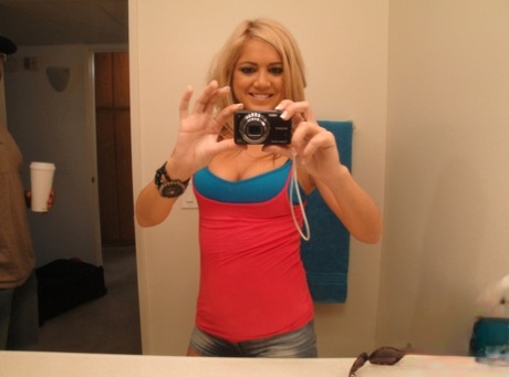 Cute blonde teen Ashley Abott snaps off self shots while undressing in mirror