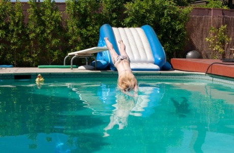 Older woman Cody Hunter slips off her bikini after going for a swim