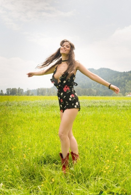 Solo girl Muirina Fae models cowgirl boots for centerfold shoot in the country