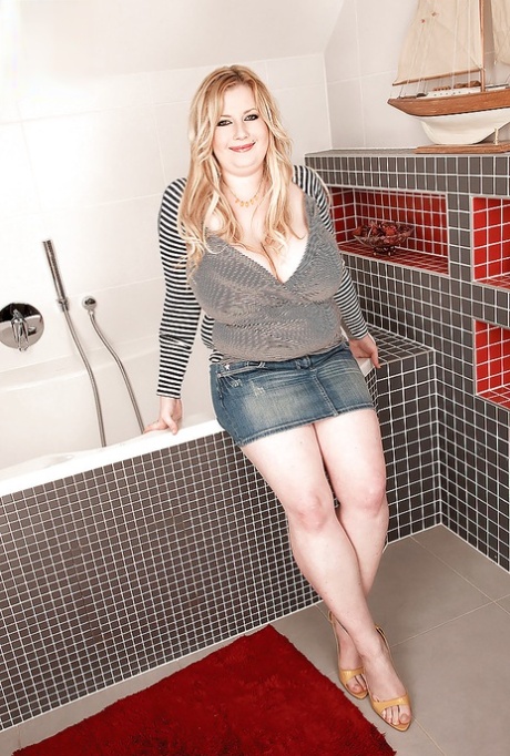 Fat blonde Anna Beck playing with her huge tits in the bathroom