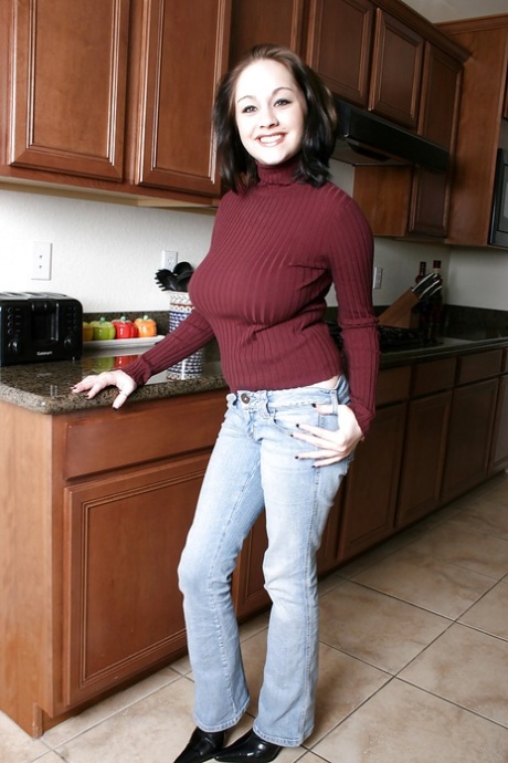 Busty teen Chelsea shows off huge tits and puffy ass in the kitchen