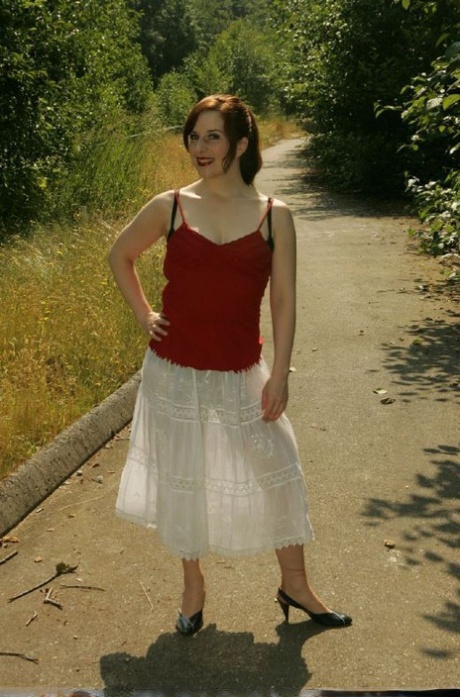 Une jeune femme sexy aux seins minuscules et à la chatte poilue se déshabille en plein air.