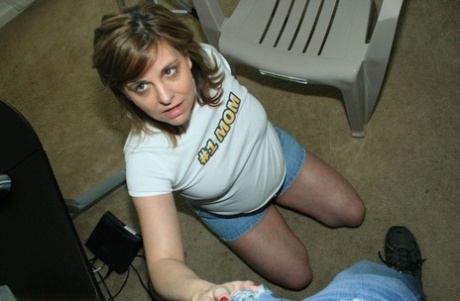 Slutty MILF in jeans shorts jerking off a big young pecker