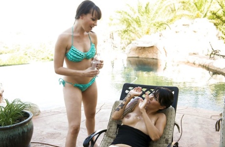 Hot lesbians Dana DeArmond & Dana Vespoli have some strapon fun outdoor