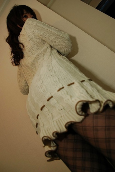 Asiatische Dame in Strumpfhosen Yukiko Moritani entkleidet und posiert auf der Couch