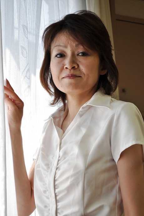 Verlegen rijpe Aziatische dame Takako Kumagaya kleedt zich uit en spreidt haar benen