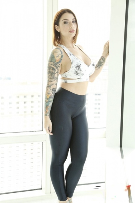 Tattooed hottie Ivy Lebelle shows her curvy body and stretches her butt