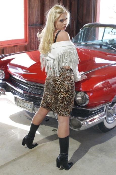 Sassy Blondine in Stiefeln Bobbi Eden Streifen, um ihre süße Pussy in der Garage zu zeigen