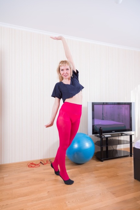 Blonde amateur lays across her exercise ball flaunting her hairy pussy