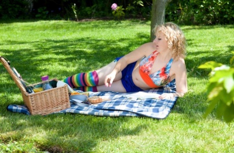 Blonde chick Rogue Rose poses in colorful socks outdoors and rubs hairy beaver
